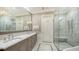 Bright bathroom features a marble shower, double vanity with marble countertop, elegant fixtures, and mosaic floor inlay at 228 Saint James Park, Osprey, FL 34229