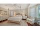 Inviting bedroom features a four poster bed, a bay window with shutters, and ample closet space at 228 Saint James Park, Osprey, FL 34229