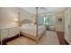 Inviting bedroom features a four poster bed, a bay window with shutters, and natural light at 228 Saint James Park, Osprey, FL 34229