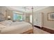 Inviting bedroom features a four poster bed, a bay window with shutters, and a wardrobe at 228 Saint James Park, Osprey, FL 34229