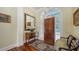 Welcoming entryway featuring a wood door, mirror, detailed rug, and traditional furnishings at 228 Saint James Park, Osprey, FL 34229