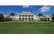 Exterior view of the clubhouse, with manicured lawn in the foreground at 228 Saint James Park, Osprey, FL 34229