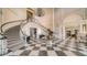 Elegant foyer with a grand staircase, black and white checkered floors, and a dazzling chandelier at 228 Saint James Park, Osprey, FL 34229