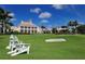 Landscaped lawns with a golf sand trap and two white Adirondack chairs at 228 Saint James Park, Osprey, FL 34229