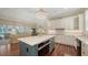 Bright eat-in kitchen that opens to living area, with large center island, sleek countertops, and modern appliances at 228 Saint James Park, Osprey, FL 34229