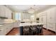 Bright eat-in kitchen features a large center island, sleek countertops, modern appliances, and ample cabinet space at 228 Saint James Park, Osprey, FL 34229