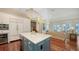 Bright eat-in kitchen that opens to living area, with large center island, sleek countertops, and wine fridge at 228 Saint James Park, Osprey, FL 34229