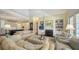 Open-concept living room with fireplace, built-in shelving, and view into kitchen area at 228 Saint James Park, Osprey, FL 34229