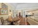 Open-concept living room leading to foyer and kitchen, featuring hardwood floors at 228 Saint James Park, Osprey, FL 34229