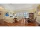 Spacious living room featuring hardwood floors, fireplace, built-in shelving, and dining area at 228 Saint James Park, Osprey, FL 34229