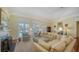 Bright living room with a fireplace, comfortable seating, and a view of the pool at 228 Saint James Park, Osprey, FL 34229