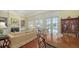 Elegant living room with hardwood floors, a fireplace, built-in shelving, and dining area at 228 Saint James Park, Osprey, FL 34229