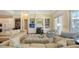 Open-concept living room with fireplace, built-in shelving, and view into kitchen area at 228 Saint James Park, Osprey, FL 34229