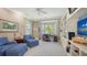 Bright and open office space includes a bay window, custom shelving, comfortable seating, and ample natural light at 228 Saint James Park, Osprey, FL 34229