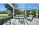 The screened patio features comfortable seating with great views at 228 Saint James Park, Osprey, FL 34229