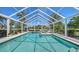 Sparkling pool with spa surrounded by lush landscaping and clear blue skies, an outdoor oasis at 228 Saint James Park, Osprey, FL 34229