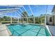 Screened-in pool with hot tub and beautiful view of the golf course and blue sky at 228 Saint James Park, Osprey, FL 34229