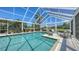 Refreshing screened pool with a hot tub and lounge furniture for ultimate relaxation and enjoyment at 228 Saint James Park, Osprey, FL 34229