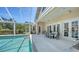The screened pool includes an outdoor dining table, seating area, grill, and plenty of space to relax at 228 Saint James Park, Osprey, FL 34229