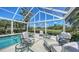 Inviting patio features a refreshing pool with lounge seating, surrounded by lush landscaping and serene views at 228 Saint James Park, Osprey, FL 34229