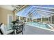 Inviting screened pool with a dining table, and an outdoor grill, perfect for relaxing and entertaining guests at 228 Saint James Park, Osprey, FL 34229