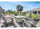 Paver patio area with Adirondack chairs and table, perfect for enjoying outdoor living and a tranquil setting at 23088 Allen Ave, Port Charlotte, FL 33980