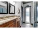 Bathroom features a double vanity, granite counters, and updated fixtures at 23088 Allen Ave, Port Charlotte, FL 33980