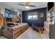 bedroom with blue accent wall, wood toned dresser and built-in shelving at 23088 Allen Ave, Port Charlotte, FL 33980