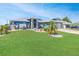 Charming single-story home featuring a well-manicured lawn and decorative landscaping at 23088 Allen Ave, Port Charlotte, FL 33980