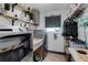 Laundry room featuring a washer, dryer, folding table, sink and shelving at 23088 Allen Ave, Port Charlotte, FL 33980