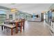 Expansive open floor plan of dining room and living room is bright and airy with wood-look tile floors at 23088 Allen Ave, Port Charlotte, FL 33980