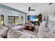 Comfortable and welcoming living room with large window, spacious seating, and beach-themed decor at 23088 Allen Ave, Port Charlotte, FL 33980