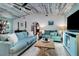 Comfortable living room features wood plank ceiling, coastal decor, and an open archway to the rest of the house at 23088 Allen Ave, Port Charlotte, FL 33980