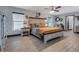 Comfortable primary bedroom features ceiling fan, updated flooring, a window with blinds and neutral color palette at 23088 Allen Ave, Port Charlotte, FL 33980