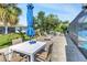 Outdoor patio with dining and lounge areas, surrounded by lush landscaping, creating a serene backyard setting at 23088 Allen Ave, Port Charlotte, FL 33980