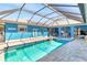 Inviting screened-in pool with a connected spa and ample patio space for lounging and entertaining guests at 23088 Allen Ave, Port Charlotte, FL 33980
