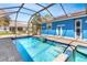Enclosed pool area with lush green lawn and outdoor seating at 23088 Allen Ave, Port Charlotte, FL 33980
