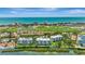 Expansive aerial view showcasing waterfront residences near a golf course and the open bay at 2450 Harbourside Dr # 233, Longboat Key, FL 34228