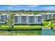 Aerial view showcasing waterfront residences, golf course, and bay views at 2450 Harbourside Dr # 233, Longboat Key, FL 34228