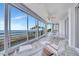Spacious enclosed lanai features expansive water views, tile flooring, and a ceiling fan at 2450 Harbourside Dr # 233, Longboat Key, FL 34228