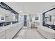 Luxurious bathroom featuring double vanity, soaking tub, and a walk-in shower with modern fixtures at 2450 Harbourside Dr # 233, Longboat Key, FL 34228