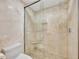 Bright bathroom showing walk-in shower featuring marble style tile and a shower seat at 2450 Harbourside Dr # 233, Longboat Key, FL 34228