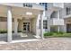 Exterior view of building entrance with lush landscaping at 2450 Harbourside Dr # 233, Longboat Key, FL 34228