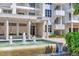 Exterior view of building with fountain and lush landscaping at 2450 Harbourside Dr # 233, Longboat Key, FL 34228