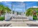 Entrance to community with palm trees and manicured landscaping at 2450 Harbourside Dr # 233, Longboat Key, FL 34228