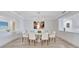 Bright dining room featuring an elegant chandelier, marble table, and custom built-ins at 2450 Harbourside Dr # 233, Longboat Key, FL 34228