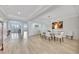 Dining room with marble table and white chairs, and natural light flowing into the space at 2450 Harbourside Dr # 233, Longboat Key, FL 34228