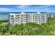 Elegant building exterior featuring multiple balconies and breathtaking waterfront views from the upper floors at 2450 Harbourside Dr # 233, Longboat Key, FL 34228