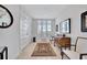 Bright foyer with travertine floors, decorative rug, and natural lighting at 2450 Harbourside Dr # 233, Longboat Key, FL 34228