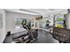 Well-equipped gym featuring modern treadmills, weight machines, and a television for entertainment at 2450 Harbourside Dr # 233, Longboat Key, FL 34228